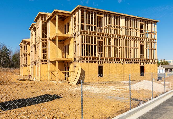 a close-up of temporary chain link fences enclosing a construction site, signaling progress in the project's development in Davison